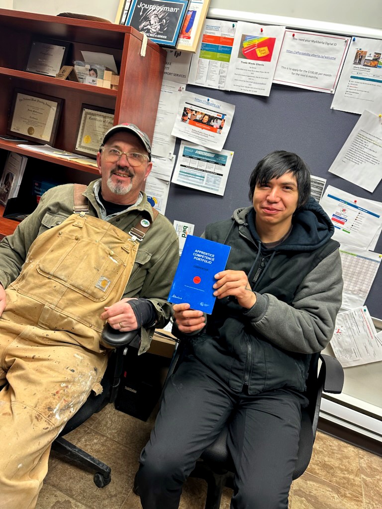 2023 Isaiah Whitebear Blue Book Signing image on The Story of Trade Winds to Success: Building Lives, Careers, and Alberta’s Economy